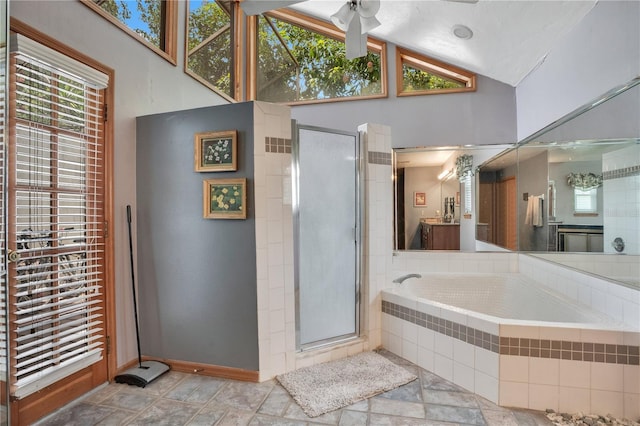 616 Magnolia St, Windermere, FL 34786 - full bathroom with ceiling fan, a garden tub, vaulted ceiling, a shower stall, and vanity