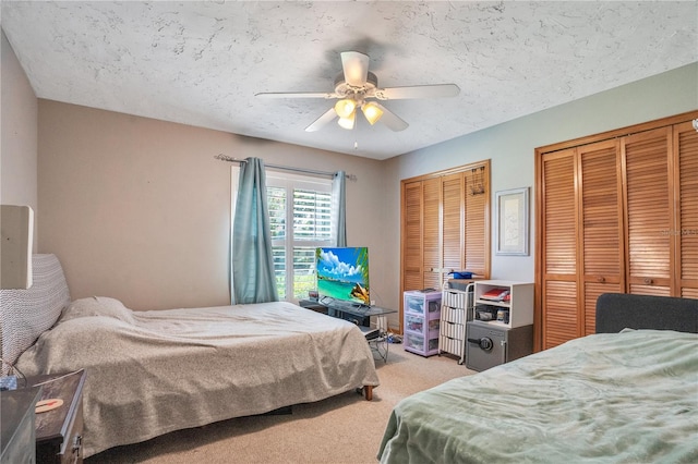 616 Magnolia St, Windermere, FL 34786 - bedroom with multiple closets, light colored carpet, ceiling fan, and a textured ceiling