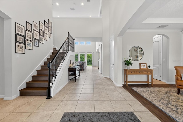 15318 Sandfield Loop, Winter Garden, FL 34787 - foyer featuring arched walkways, stairs, light tile patterned floors, recessed lighting, and baseboards