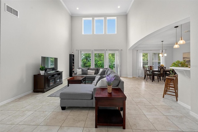 15318 Sandfield Loop, Winter Garden, FL 34787 - living area with arched walkways, ornamental molding, healthy amount of natural light, light tile patterned flooring, and baseboards