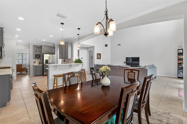 15318 Sandfield Loop, Winter Garden, FL 34787 - dining area featuring light tile patterned flooring, ornamental molding, recessed lighting, arched walkways, and baseboards