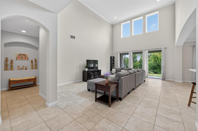 15318 Sandfield Loop, Winter Garden, FL 34787 - living area with arched walkways, light tile patterned floors, ornamental molding, a towering ceiling, and baseboards