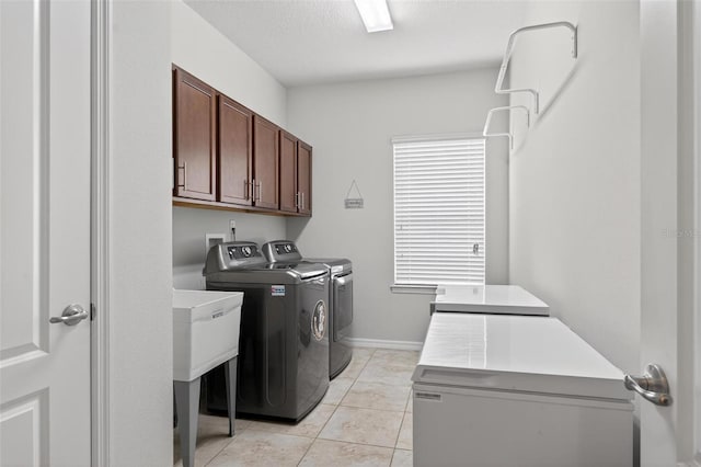 15318 Sandfield Loop, Winter Garden, FL 34787 - laundry room with cabinet space, washer and dryer, light tile patterned floors, and baseboards