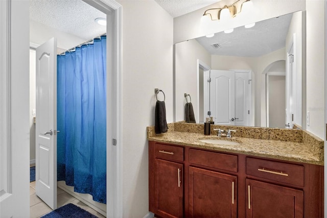 15318 Sandfield Loop, Winter Garden, FL 34787 - bathroom featuring a textured ceiling, vanity, tile patterned flooring, and a shower with curtain