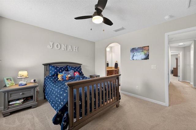 15318 Sandfield Loop, Winter Garden, FL 34787 - carpeted bedroom with baseboards, a textured ceiling, ceiling fan, and arched walkways