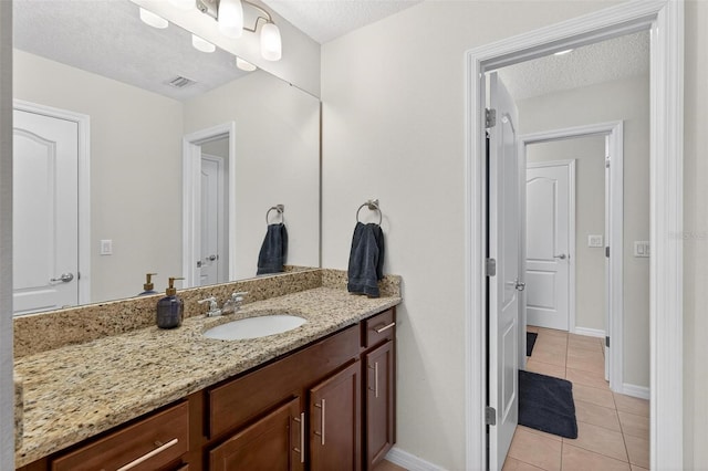 15318 Sandfield Loop, Winter Garden, FL 34787 - bathroom featuring tile patterned floors, vanity, a textured ceiling, and baseboards