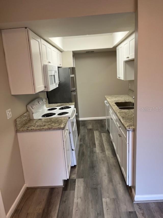 2776 Curry Ford Rd Ge, Unit Ge, Orlando, FL 32806 - kitchen with white appliances, dark wood-style flooring, white cabinetry, and light stone countertops