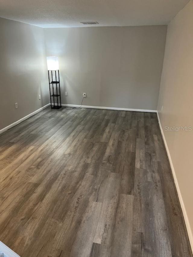 2776 Curry Ford Rd Ge, Unit Ge, Orlando, FL 32806 - unfurnished room with dark wood-style flooring and baseboards