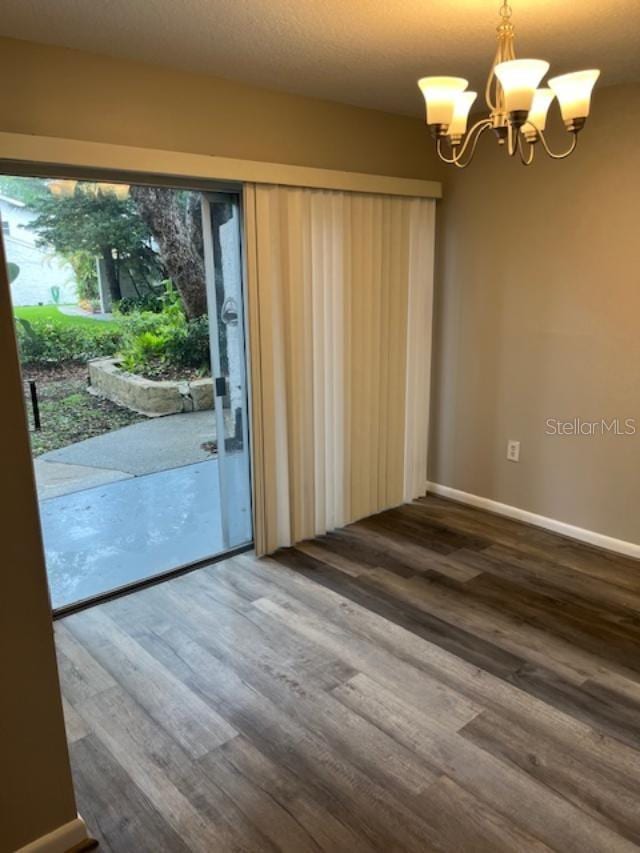 2776 Curry Ford Rd Ge, Unit Ge, Orlando, FL 32806 - unfurnished dining area with wood finished floors and a chandelier