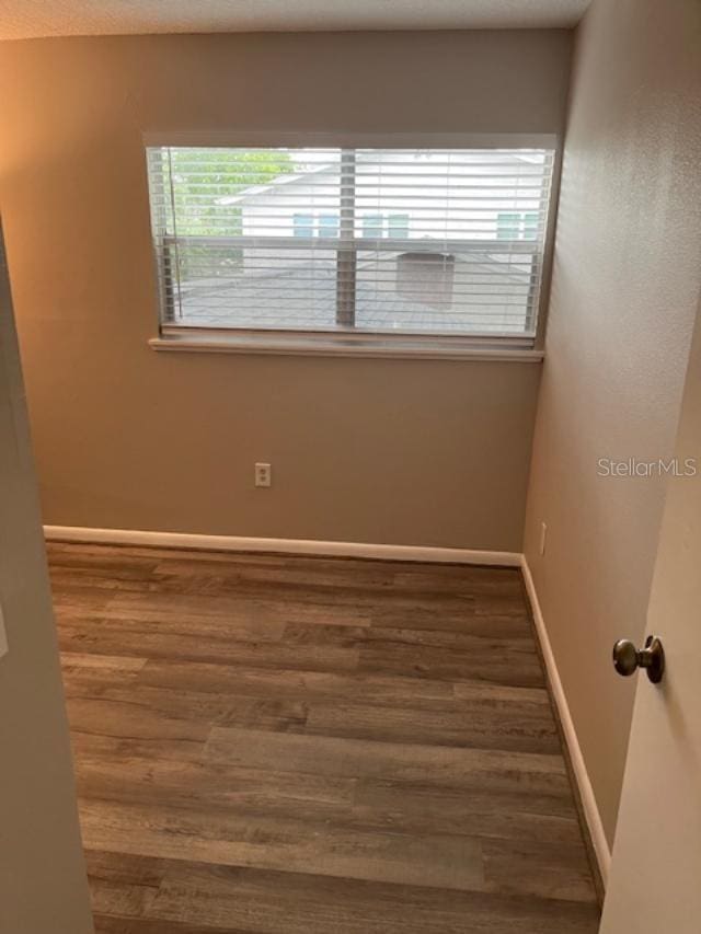 2776 Curry Ford Rd Ge, Unit Ge, Orlando, FL 32806 - spare room with wood finished floors and baseboards