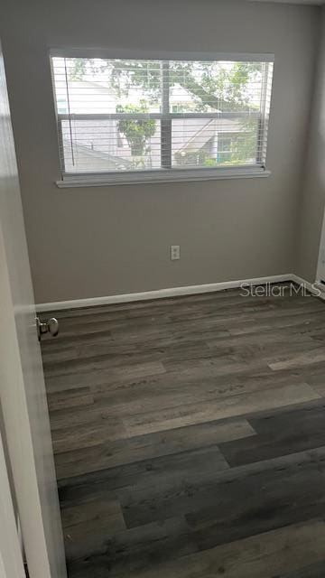 2776 Curry Ford Rd Ge, Unit Ge, Orlando, FL 32806 - spare room featuring dark wood finished floors and baseboards