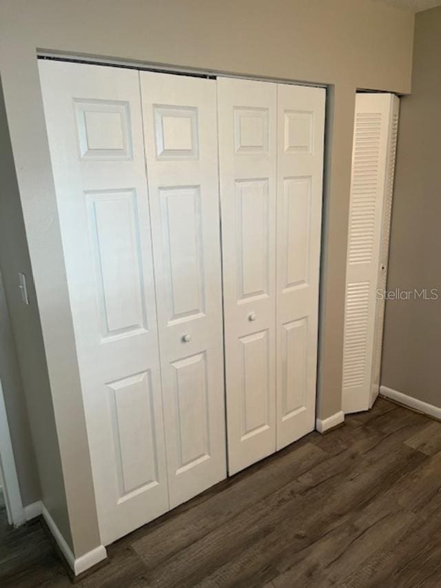2776 Curry Ford Rd Ge, Unit Ge, Orlando, FL 32806 - unfurnished bedroom with baseboards and dark wood finished floors