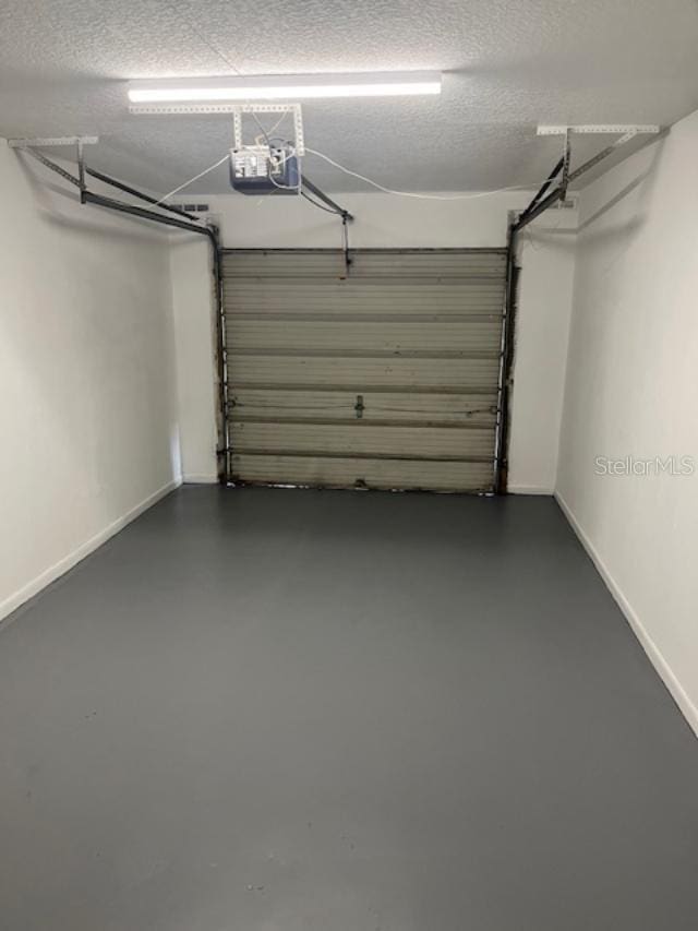 2776 Curry Ford Rd Ge, Unit Ge, Orlando, FL 32806 - garage featuring a garage door opener and baseboards