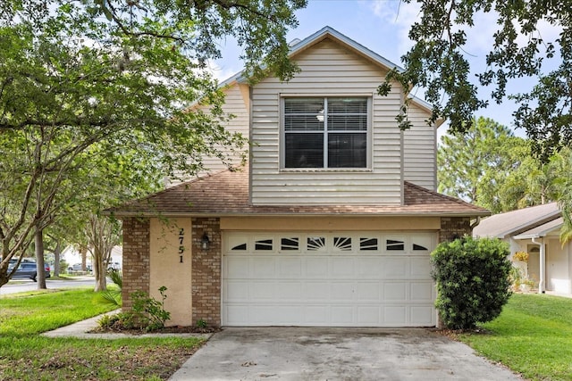 2751 Wentworth Pl, Cocoa, FL 32926 - traditional home with an attached garage, driveway, a front yard, and a shingled roof