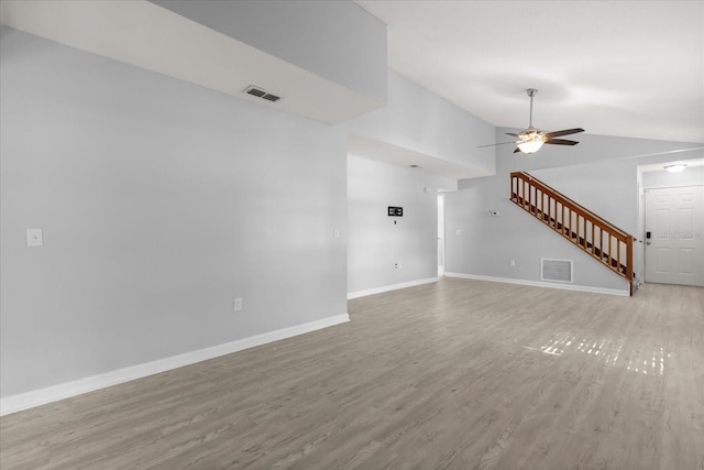 2751 Wentworth Pl, Cocoa, FL 32926 - unfurnished living room featuring lofted ceiling, light wood-type flooring, a ceiling fan, and stairs