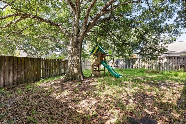 2751 Wentworth Pl, Cocoa, FL 32926 - fenced backyard featuring a playground