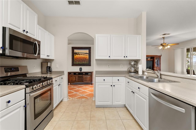 2696 Clearview St, Clermont, FL 34711 - kitchen featuring stainless steel appliances, light tile patterned flooring, white cabinets, and light countertops