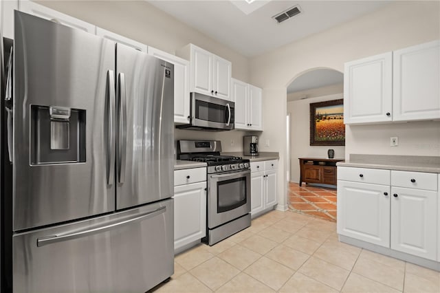 2696 Clearview St, Clermont, FL 34711 - kitchen featuring stainless steel appliances, light tile patterned floors, and white cabinets