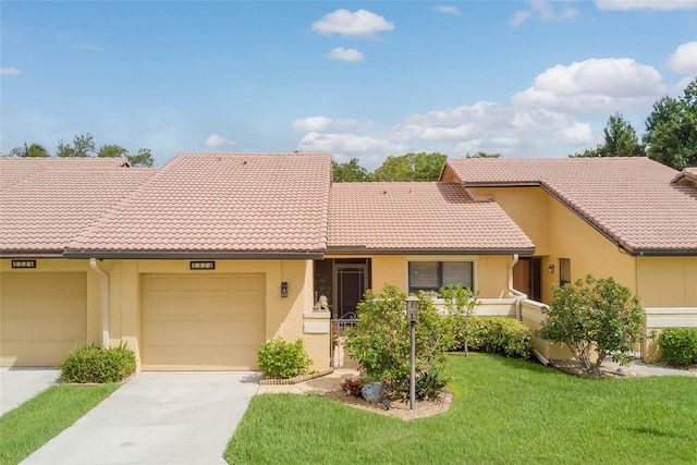 5323 Concord Way, Fort Myers, FL 33907 - view of front facade with concrete driveway, stucco siding, a garage, and a tile roof