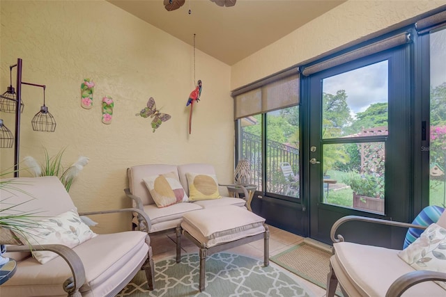 5323 Concord Way, Fort Myers, FL 33907 - living area with a textured wall, vaulted ceiling, tile patterned floors, and a ceiling fan