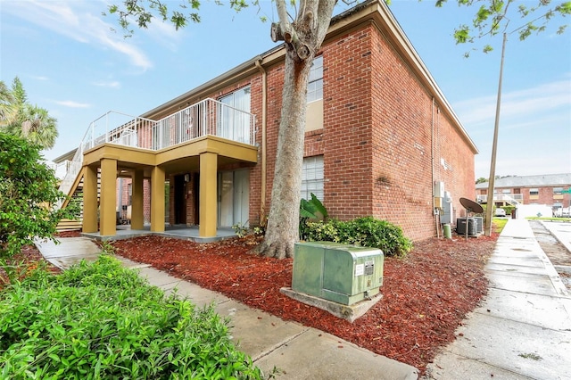 2520 Caper Ln Unit 206, Maitland, FL 32751 - rear view of property featuring brick siding, a balcony, and central air condition unit
