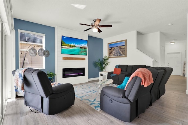 15613 Camp Dubois Cres, Winter Garden, FL 34787 - living area with ceiling fan, wood finished floors, a fireplace, and baseboards