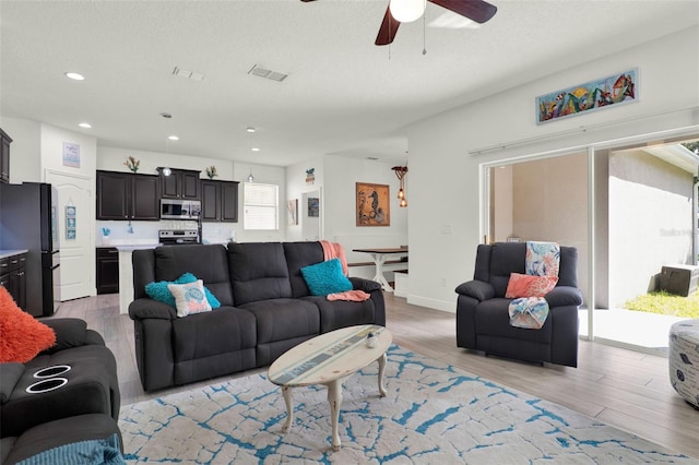 15613 Camp Dubois Cres, Winter Garden, FL 34787 - living area with light wood finished floors, a ceiling fan, and recessed lighting