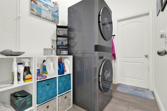 15613 Camp Dubois Cres, Winter Garden, FL 34787 - laundry room featuring stacked washer / drying machine, wood finished floors, and baseboards