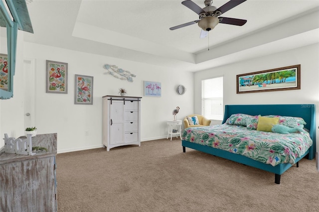 15613 Camp Dubois Cres, Winter Garden, FL 34787 - carpeted bedroom featuring a tray ceiling, baseboards, and a ceiling fan