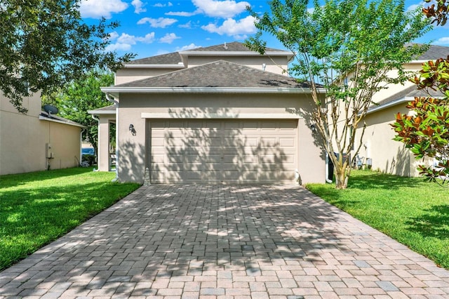 15613 Camp Dubois Cres, Winter Garden, FL 34787 - view of front of home featuring an attached garage, decorative driveway, a front lawn, stucco siding, and a shingled roof