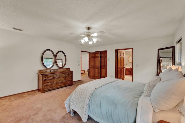 1778 Woodcrest Ln, Deland, FL 32720 - bedroom with light colored carpet, a textured ceiling, a ceiling fan, and ensuite bathroom