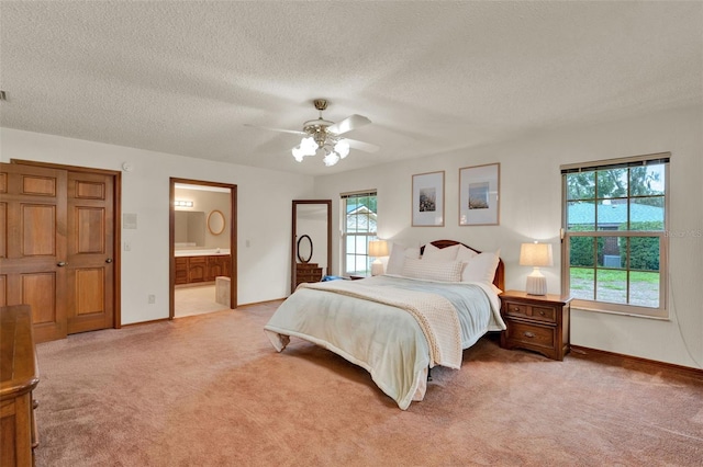 1778 Woodcrest Ln, Deland, FL 32720 - bedroom featuring light colored carpet, a textured ceiling, connected bathroom, and ceiling fan