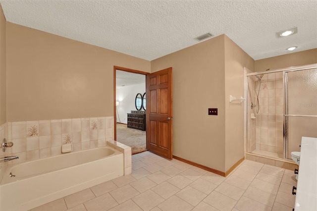 1778 Woodcrest Ln, Deland, FL 32720 - bathroom featuring tile patterned flooring, a garden tub, a stall shower, and a textured ceiling
