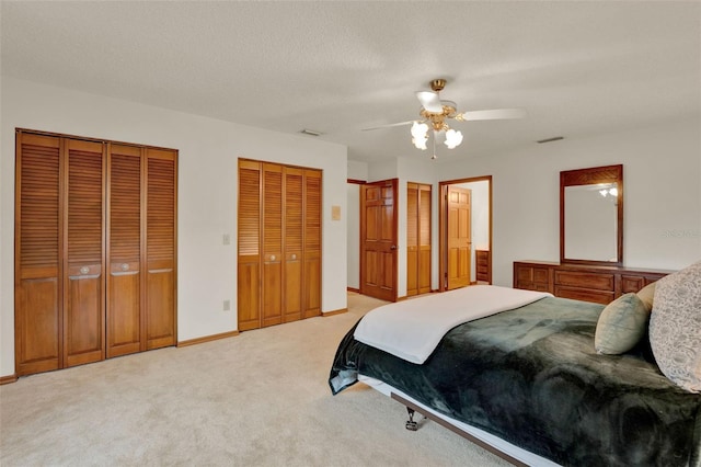 1778 Woodcrest Ln, Deland, FL 32720 - bedroom with multiple closets, light carpet, and ceiling fan