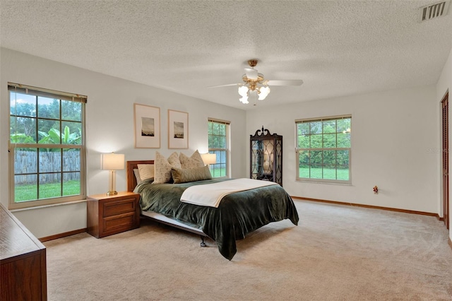 1778 Woodcrest Ln, Deland, FL 32720 - bedroom with light carpet, multiple windows, a ceiling fan, and a textured ceiling