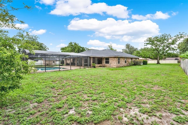 1778 Woodcrest Ln, Deland, FL 32720 - rear view of property with a fenced backyard and glass enclosure