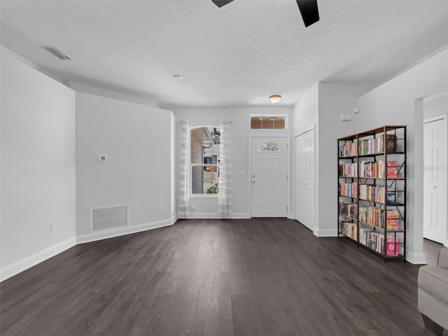 917 Dekleva Dr, Apopka, FL 32712 - foyer entrance featuring dark wood finished floors, a textured ceiling, and baseboards