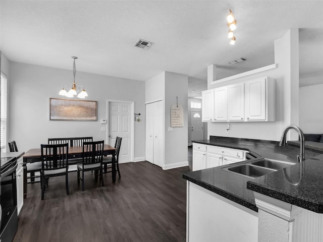 917 Dekleva Dr, Apopka, FL 32712 - kitchen with a sink, dark countertops, white cabinets, and a chandelier