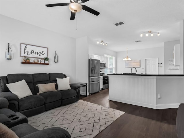 917 Dekleva Dr, Apopka, FL 32712 - living room featuring a ceiling fan, dark wood-style floors, a chandelier, and baseboards