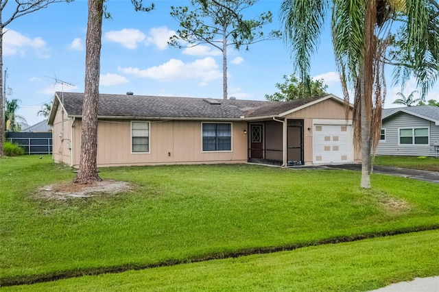 281 NE Greenbrier Ave, Port St Lucie, FL 34983 - ranch-style home featuring a garage, driveway, a front lawn, and roof with shingles