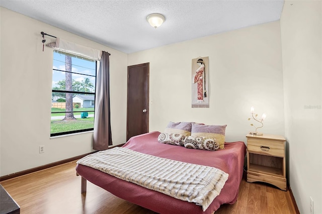 281 NE Greenbrier Ave, Port St Lucie, FL 34983 - bedroom with wood finished floors and a textured ceiling