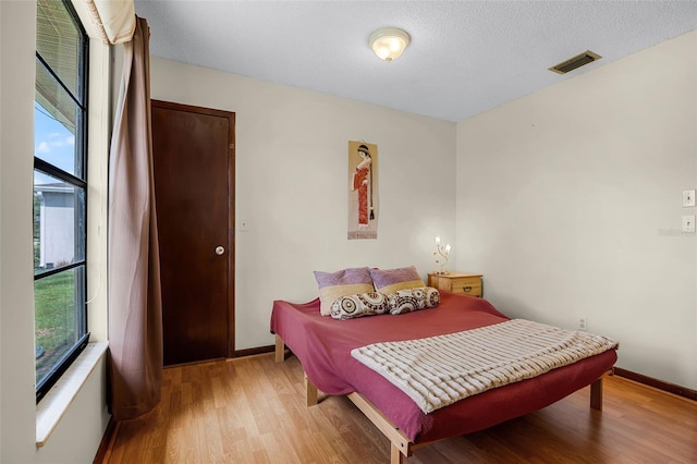 281 NE Greenbrier Ave, Port St Lucie, FL 34983 - bedroom with light wood-style flooring and baseboards