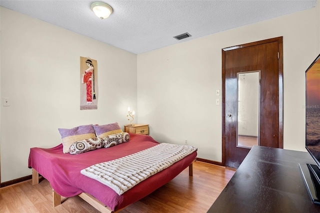 281 NE Greenbrier Ave, Port St Lucie, FL 34983 - bedroom featuring light wood-type flooring and a textured ceiling