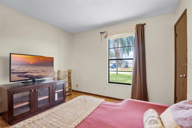 281 NE Greenbrier Ave, Port St Lucie, FL 34983 - bedroom with wood finished floors and a textured ceiling