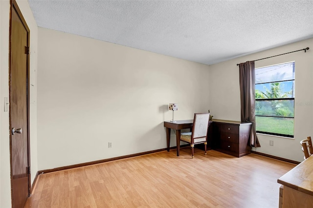 281 NE Greenbrier Ave, Port St Lucie, FL 34983 - home office with light wood-type flooring and a textured ceiling