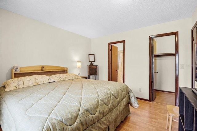281 NE Greenbrier Ave, Port St Lucie, FL 34983 - bedroom featuring light wood-style floors, a spacious closet, and a closet