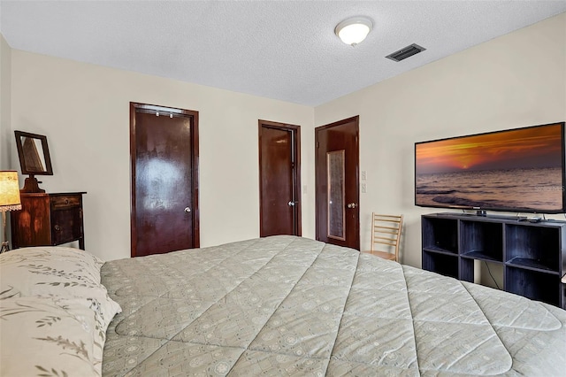 281 NE Greenbrier Ave, Port St Lucie, FL 34983 - bedroom featuring a textured ceiling and two closets
