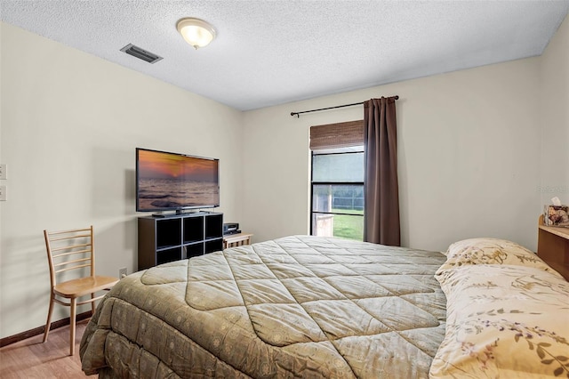281 NE Greenbrier Ave, Port St Lucie, FL 34983 - bedroom featuring wood finished floors and a textured ceiling