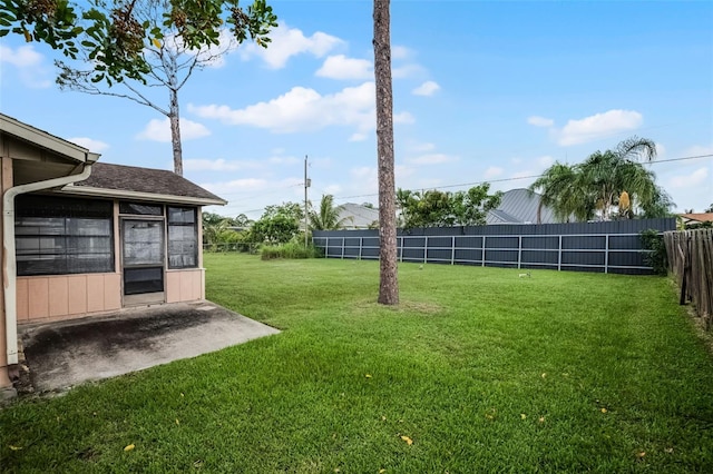 281 NE Greenbrier Ave, Port St Lucie, FL 34983 - fenced backyard with a sunroom and a patio area