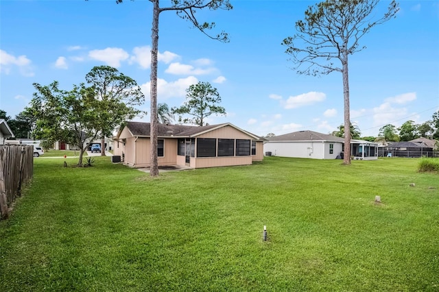 281 NE Greenbrier Ave, Port St Lucie, FL 34983 - rear view of house featuring a sunroom